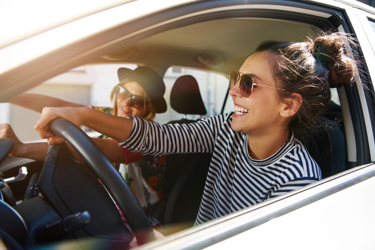 Travel buddies having fun while driving